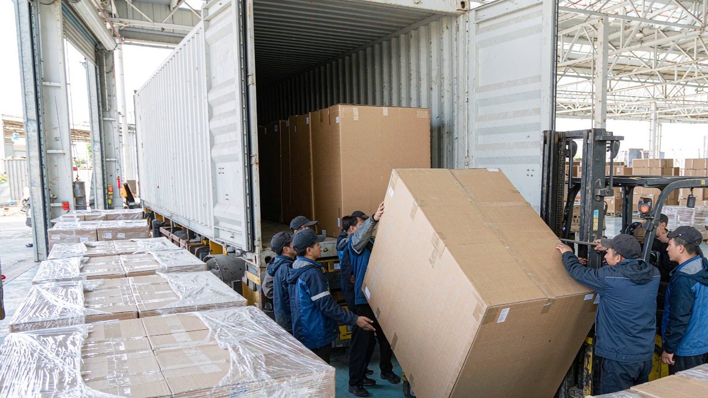Furniture cartons being loaded into a 40-foot high cube container at the PatioHue loading dock in Foshan