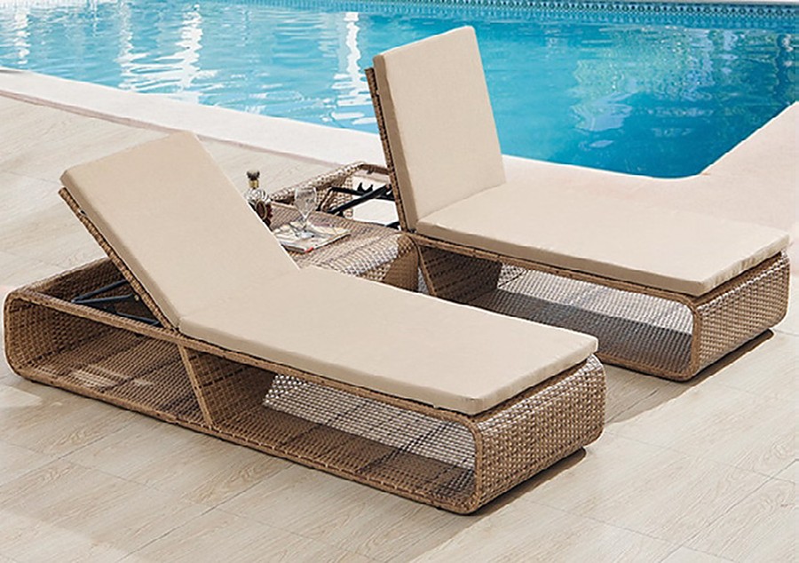 Honey-toned woven sun loungers beside a resort pool, T2009